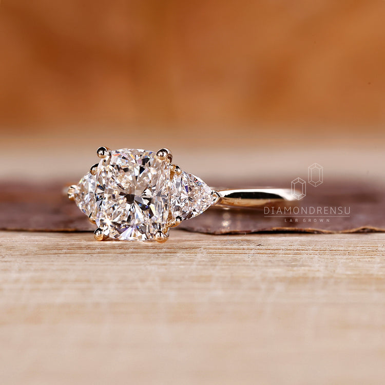 Handmade cushion cut diamond ring with tapered band design.