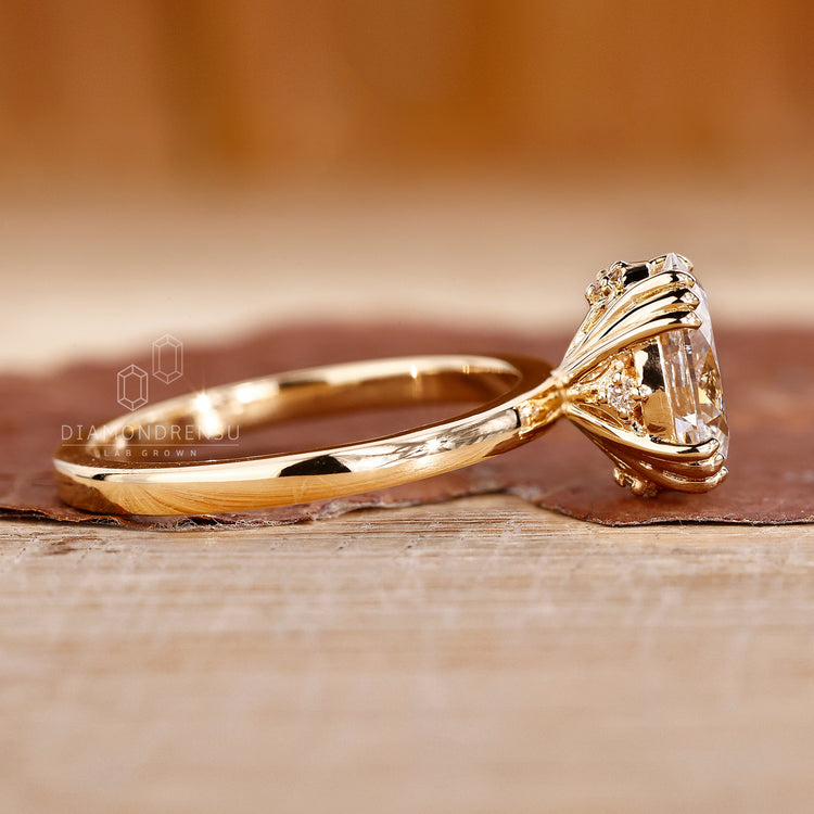 Oval cut diamond ring with round hidden accent details.
