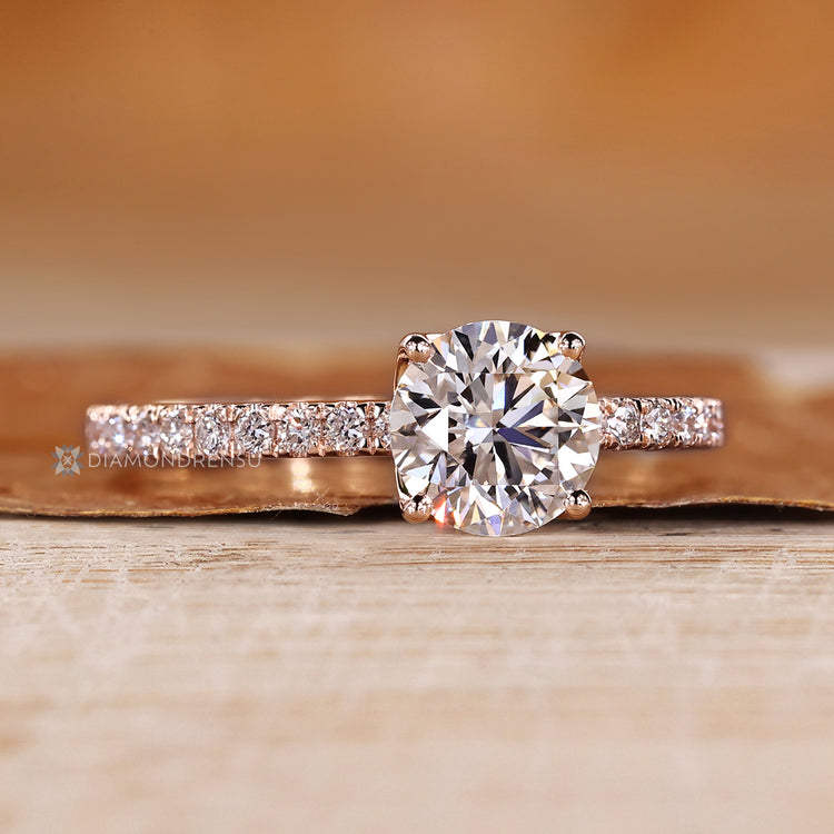 Round cut engagement ring with pavé style diamonds.