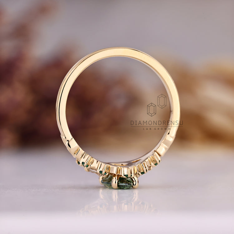 Cluster setting ring with green centre diamond.