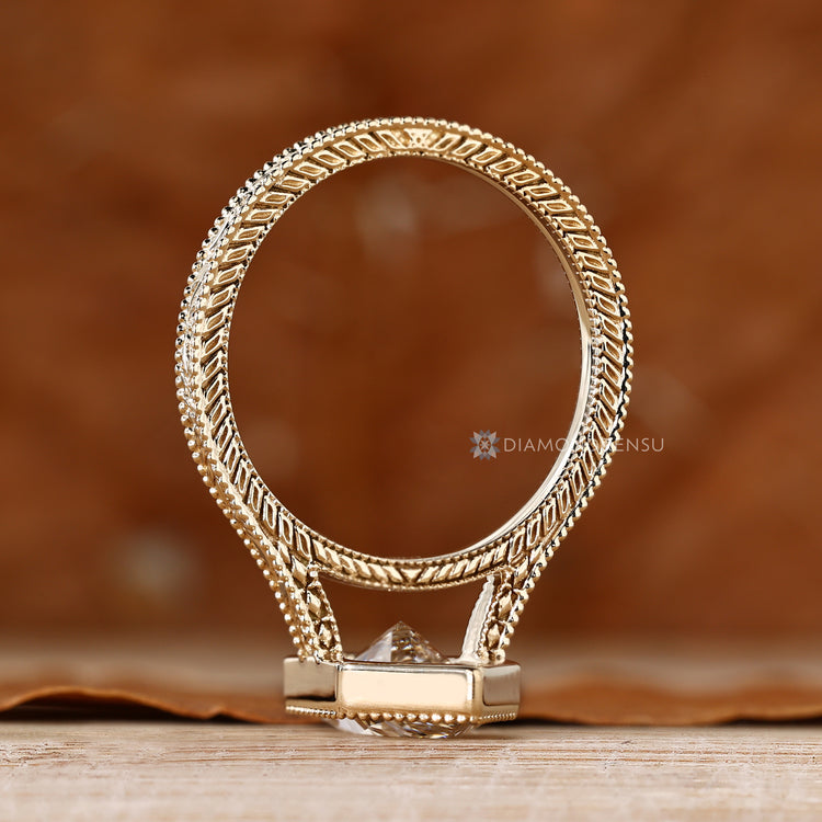Art Deco solitaire ring with milgrain detailing.