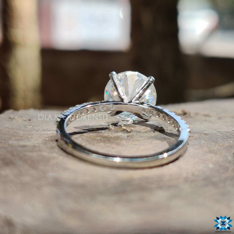 Custom engagement ring with round moissanite and pave band.