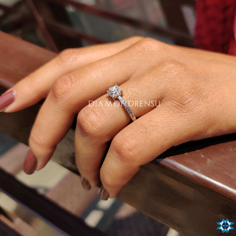 Moissanite halo ring in white gold with pave accents.