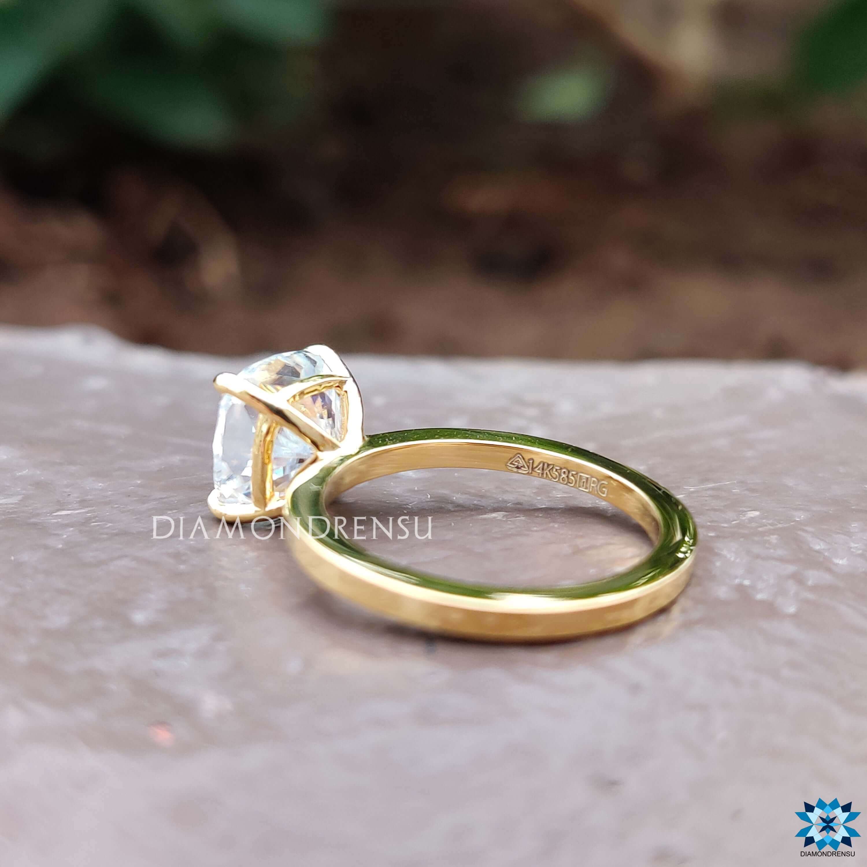 Solitaire setting featuring a cushion cut moissanite in 4 prong claws.