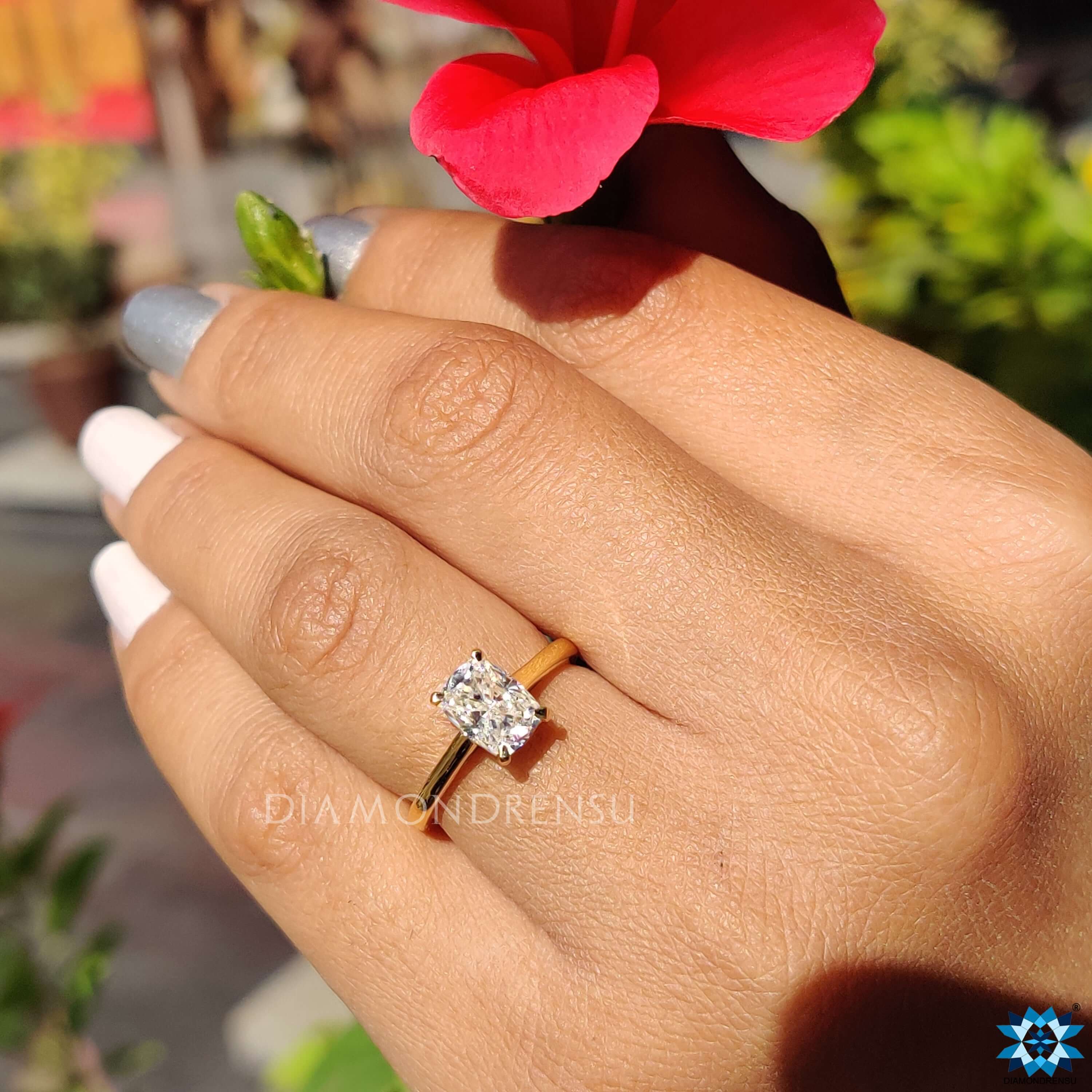 Diamondrensu UK engagement ring featuring an elongated cushion center.