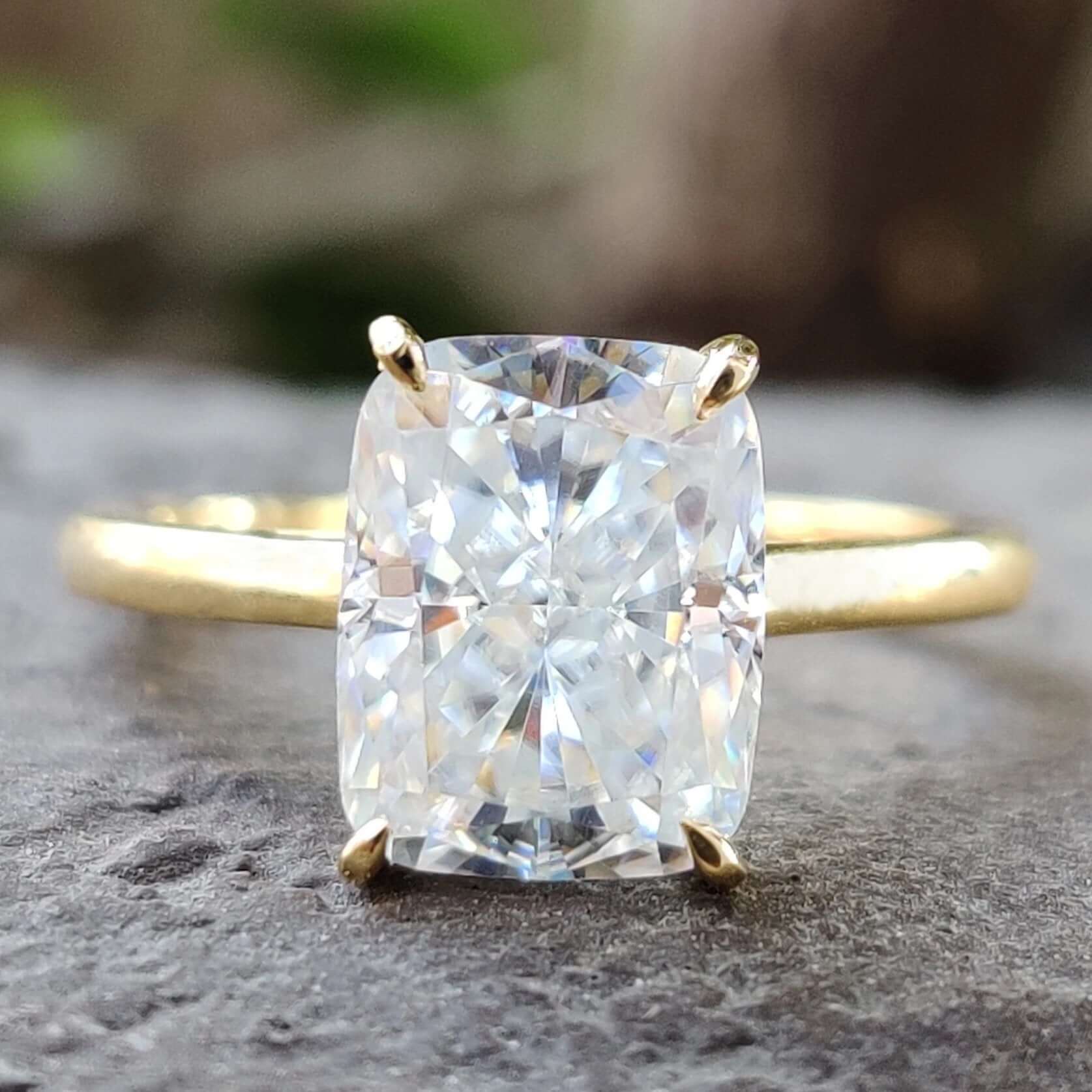 Elongated cushion cut moissanite ring in a classic solitaire setting.