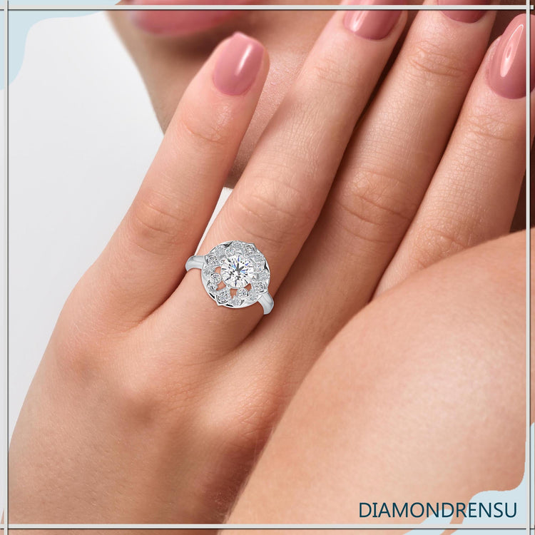 Antique engagement ring in white gold with round prong setting.