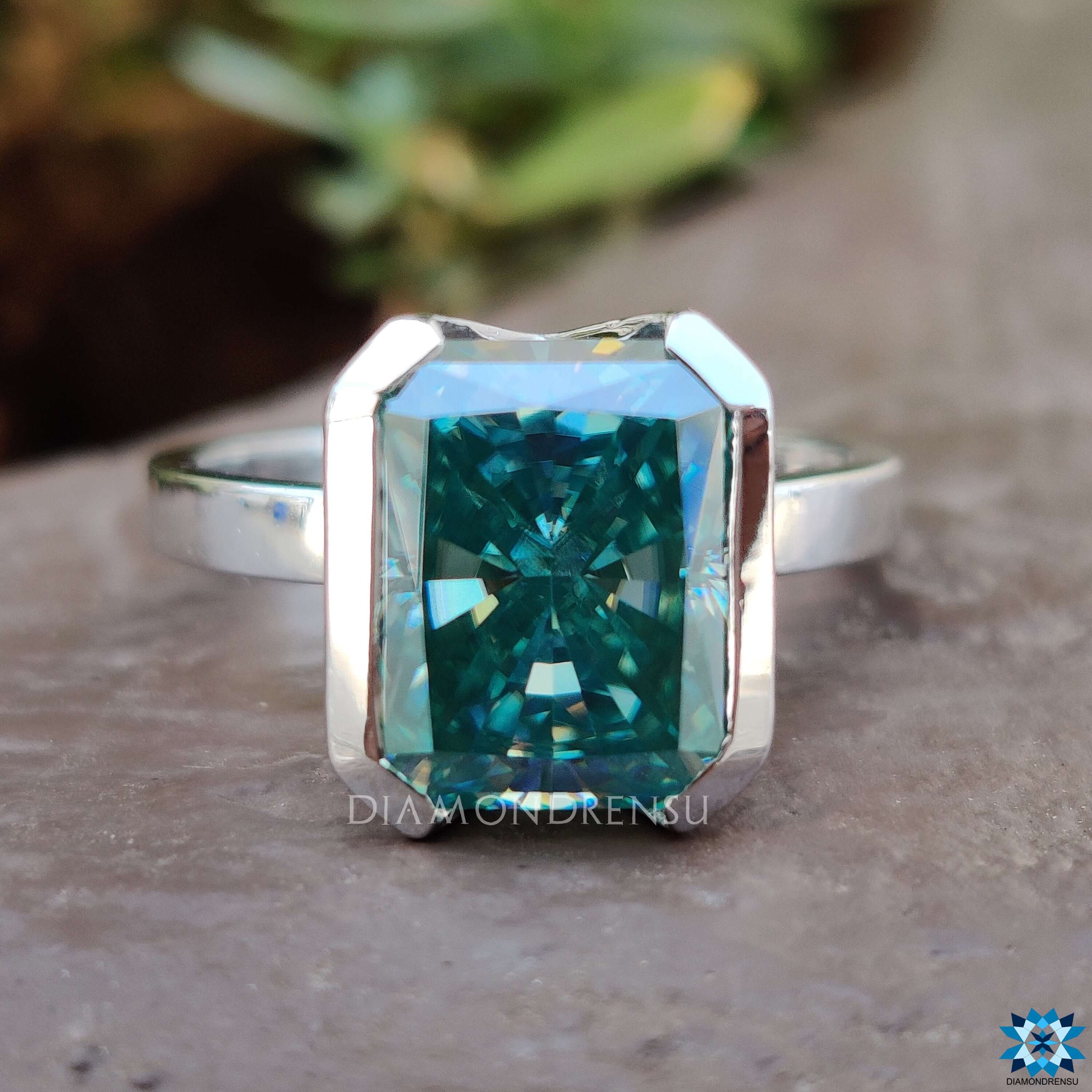Handmade radiant cut moissanite ring with half bezel mount.