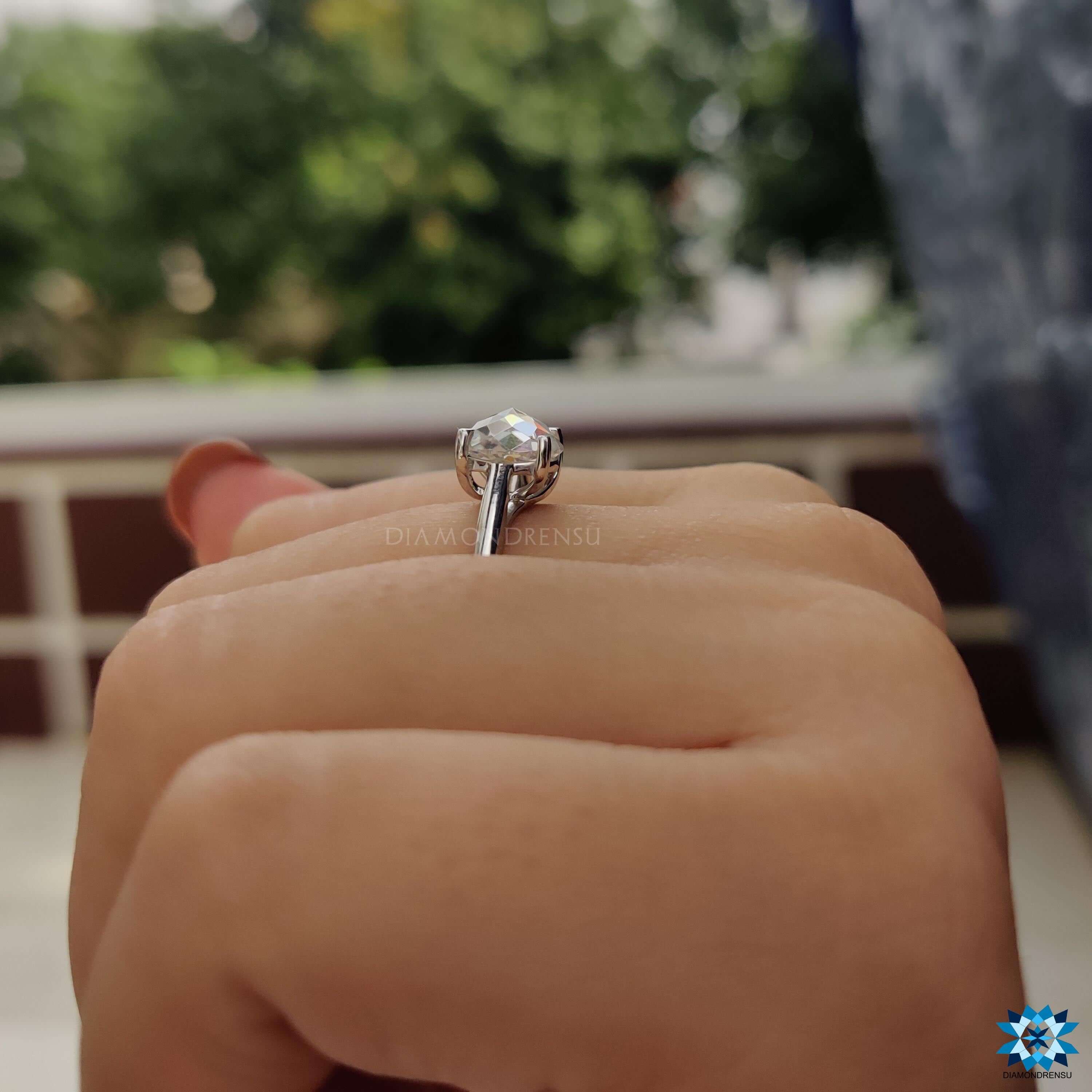 Minimalist moissanite ring with round rose cut center.