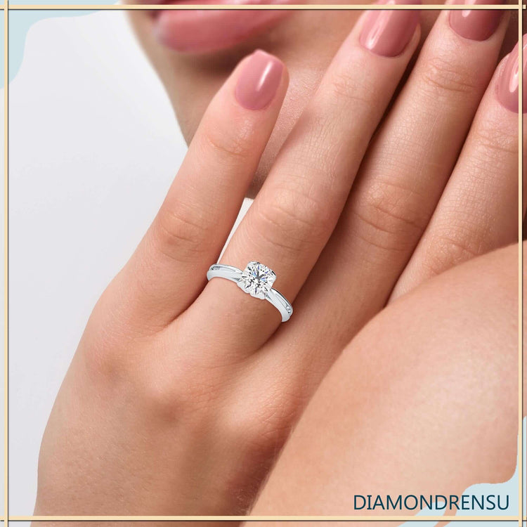 Tulip ring design with lab grown diamond in a cathedral setting.