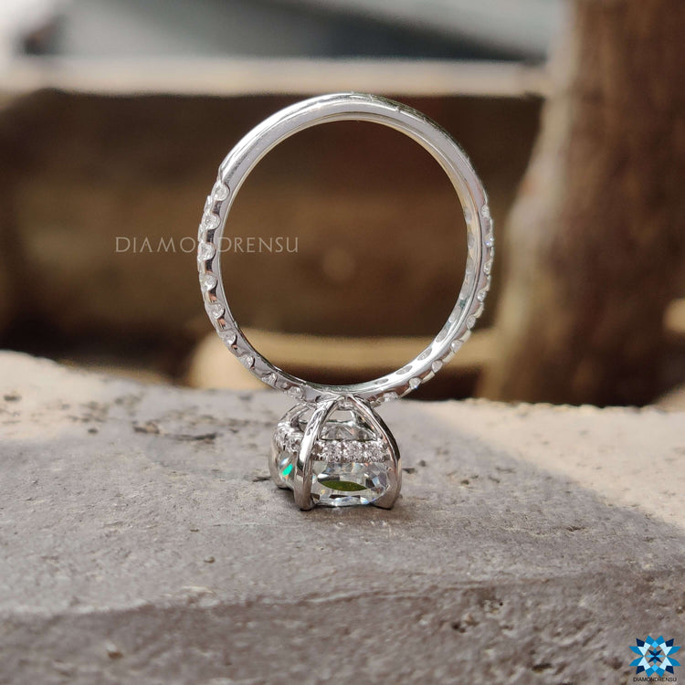 Cushion cut ring featuring hidden halo and tab prongs.