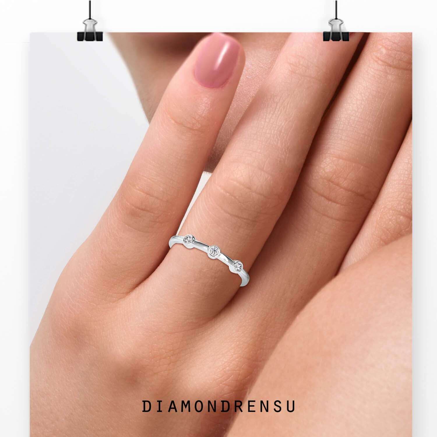 Three stone diamond band in bezel setting design.