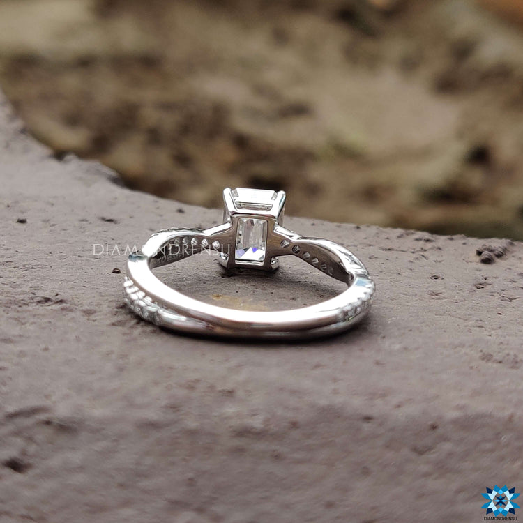 Moissanite engagement ring with twisted round pave design.
