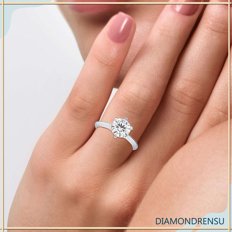 Yellow gold solitaire ring featuring round diamond and simple design.