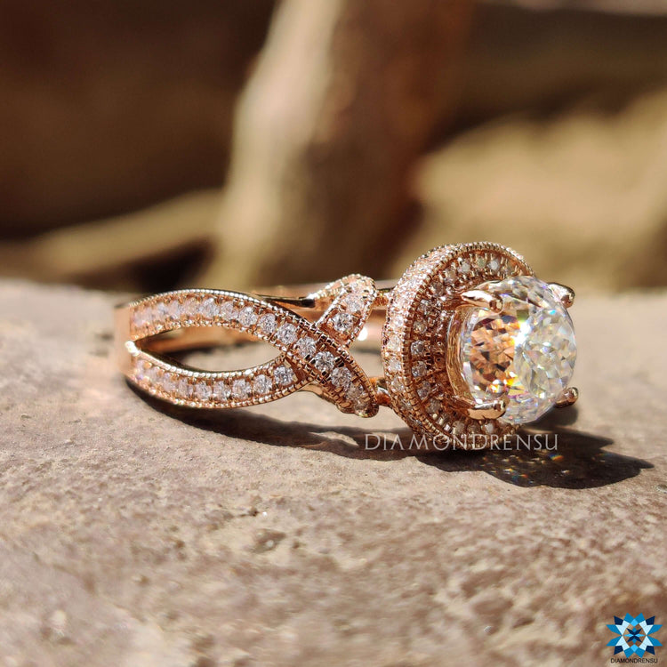 Split shank engagement ring with milgrain halo setting.