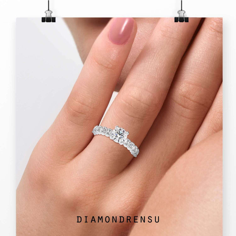 Round diamond ring with pave band design in white gold.