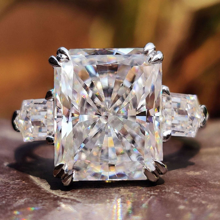 Three stone radiant cut moissanite engagement ring in white gold.
