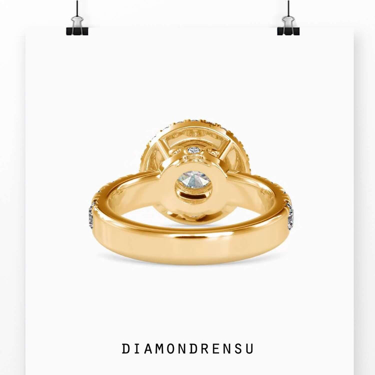 Buy engagement ring with round diamond centre and side stones in yellow gold.