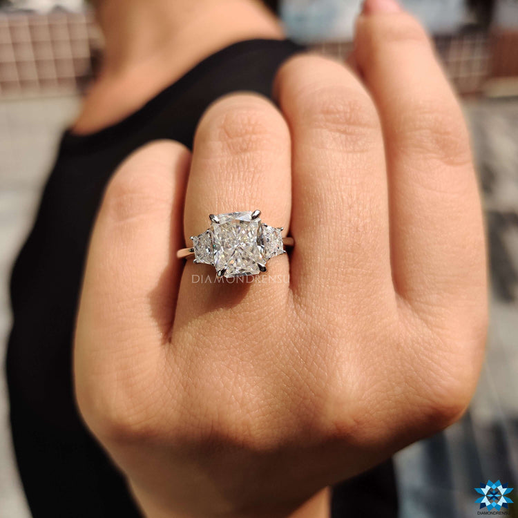 White gold moissanite ring with trapezoid side stones.