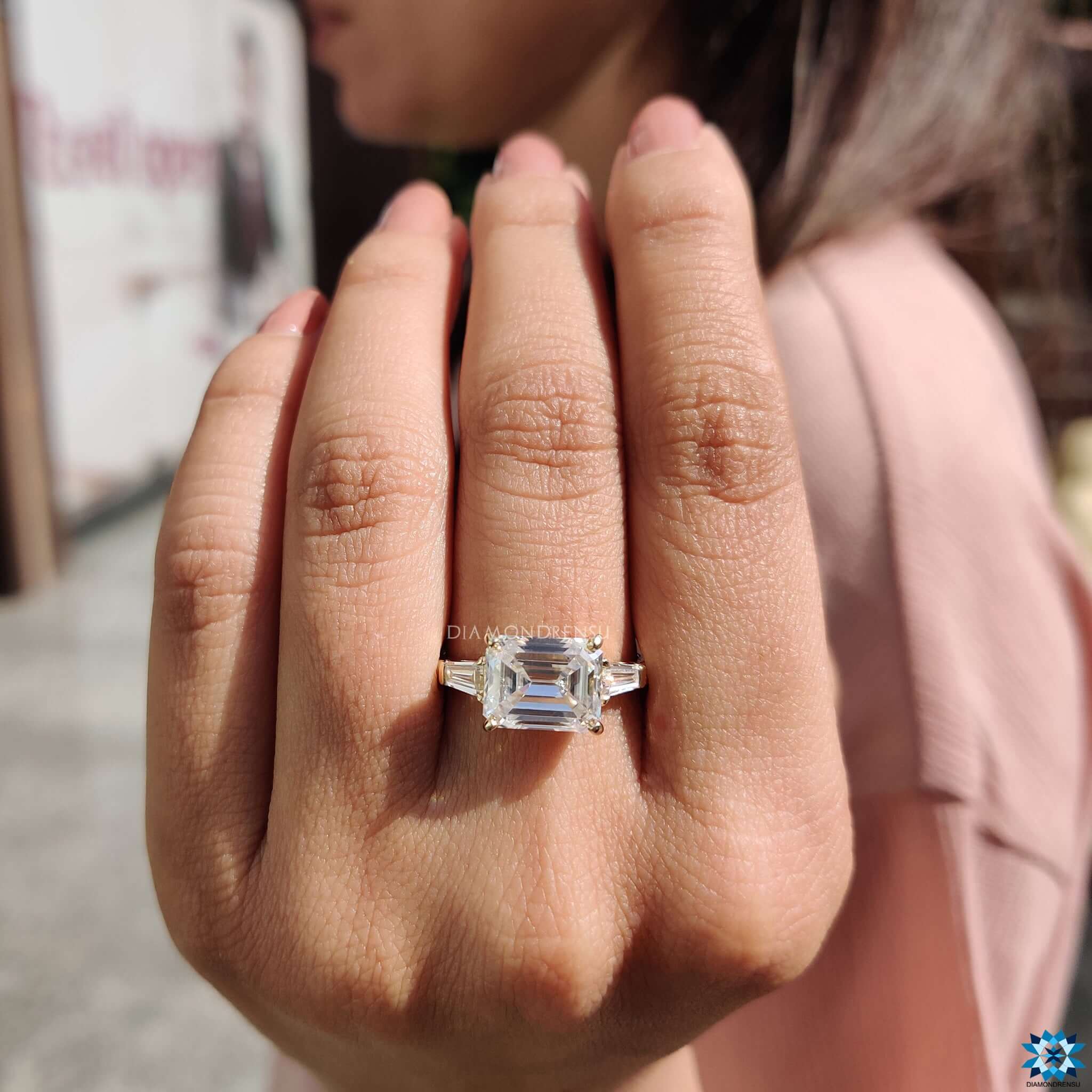 Three stone engagement ring in yellow gold.