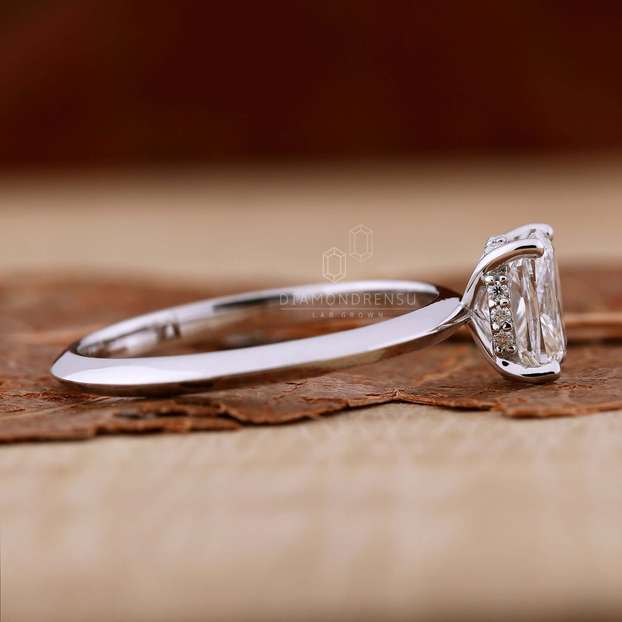 4 prong round diamond engagement ring with an elongated cushion for a minimalist style.
