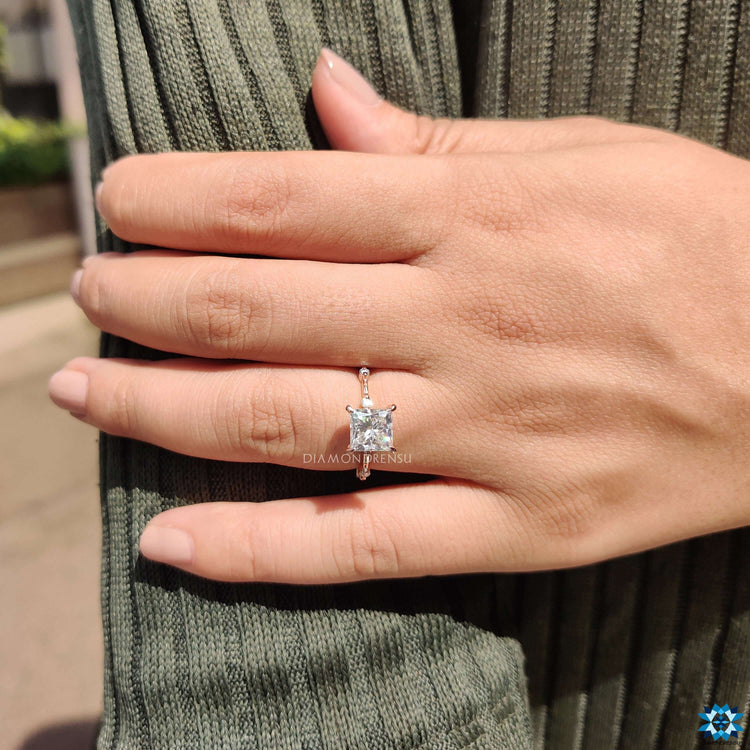 Floating bubble pave ring with princess cut center.