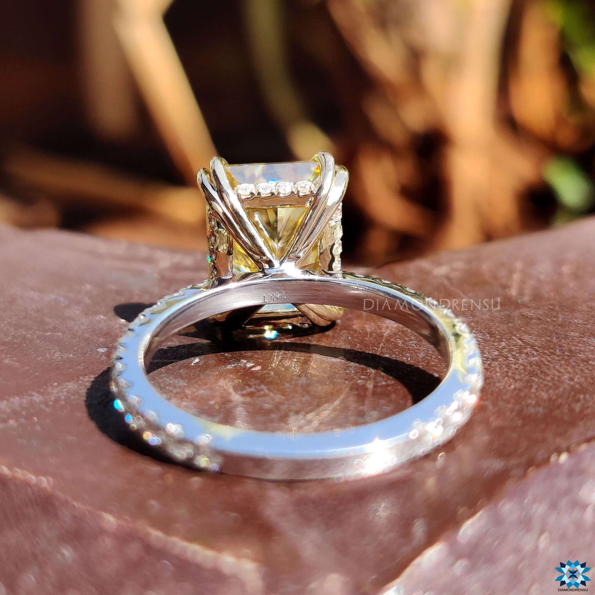 Handmade moissanite engagement ring in white and yellow gold.