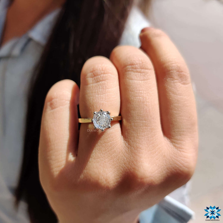 Yellow gold moissanite ring with tapered shank.