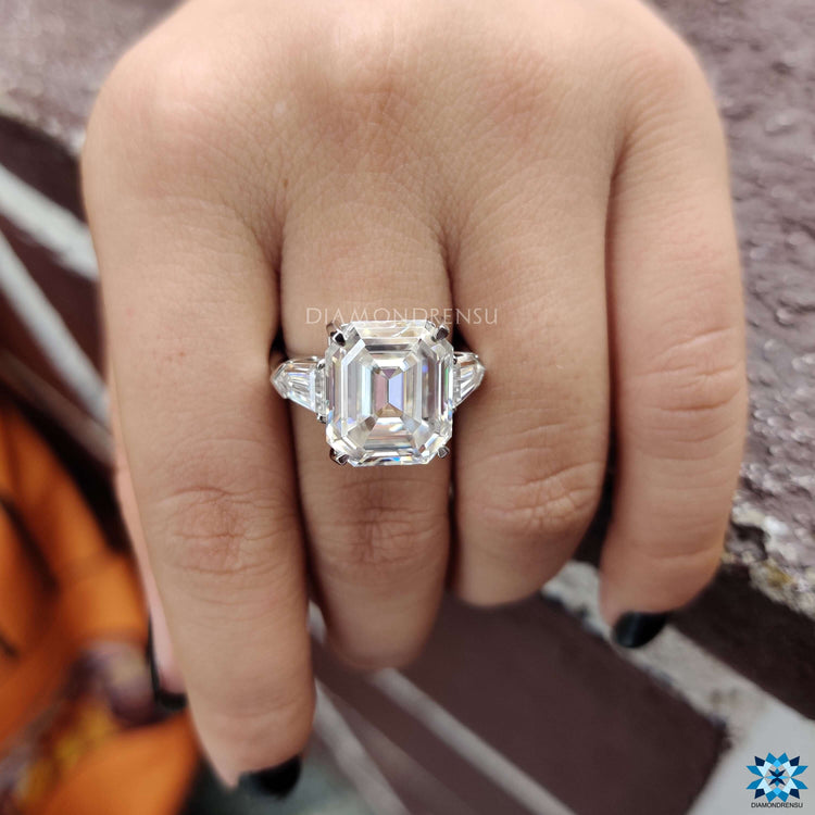 Three stone white gold ring featuring Krupps cut emerald center.