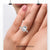 Emerald cut centre stone with round diamond halo setting.
 Emerald cut centre stone with round diamond halo setting.