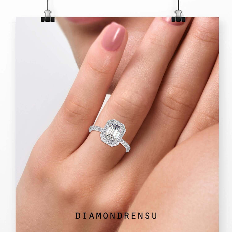 Emerald cut centre stone with round diamond halo setting.