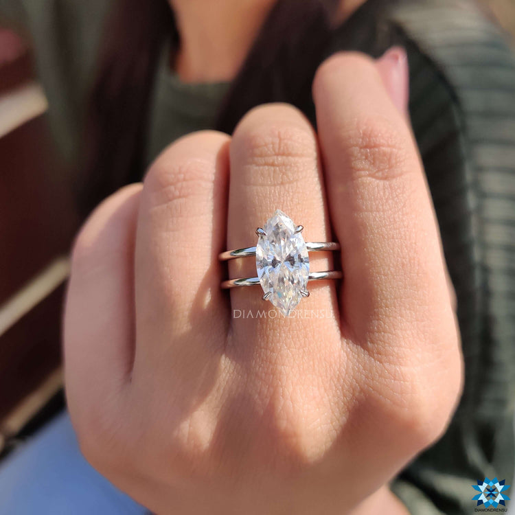 Solitaire engagement ring with marquise cut and handcrafted detail.