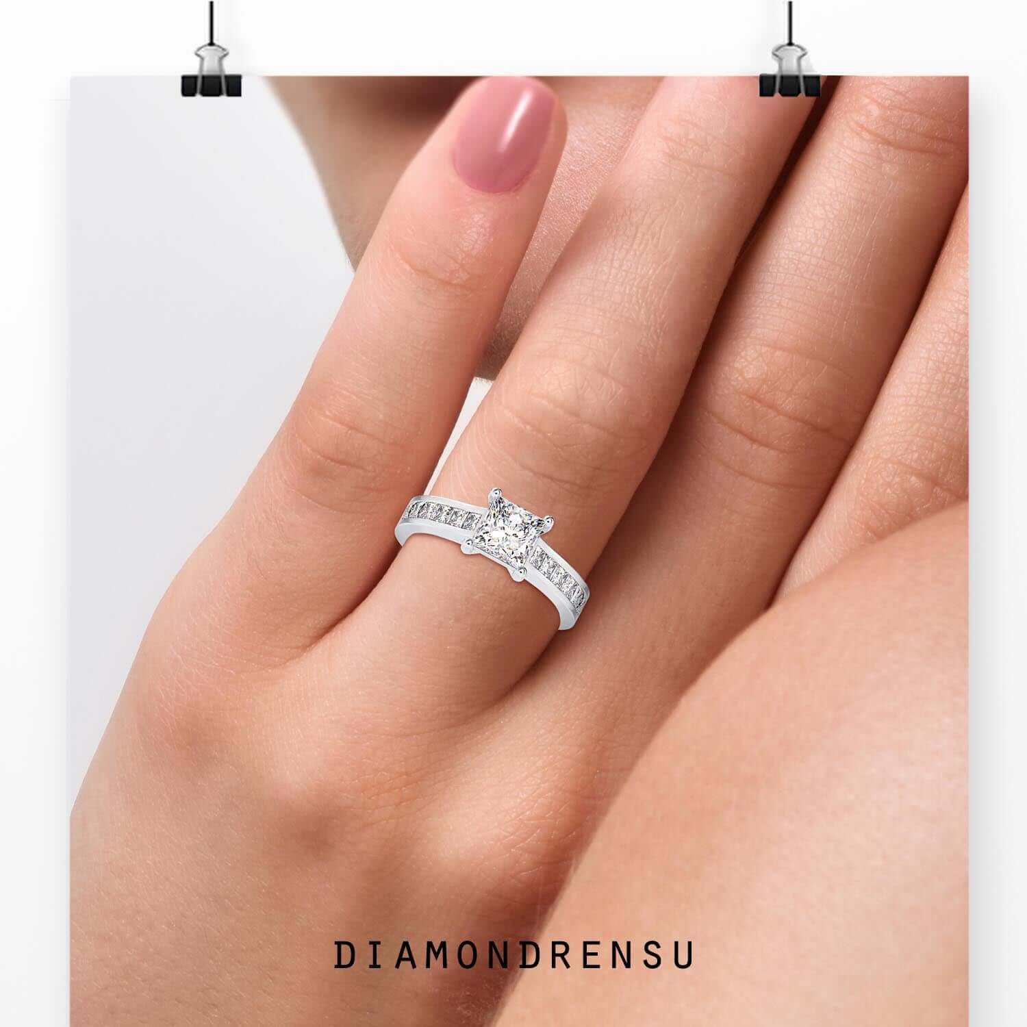 Channel set engagement ring with princess cut centre diamond.