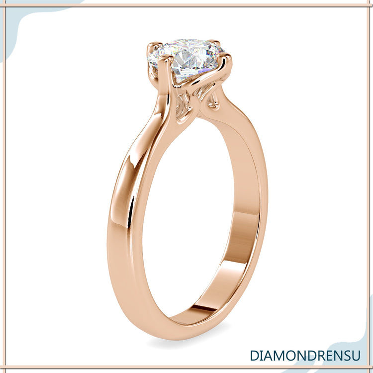 White gold engagement ring with round diamond and tab prongs.