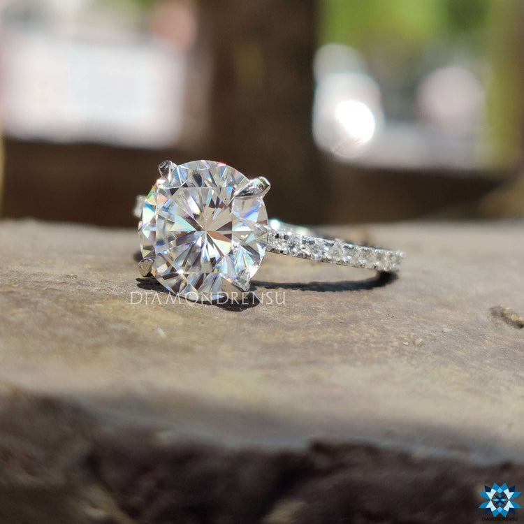 Pave accent setting on round moissanite engagement ring.