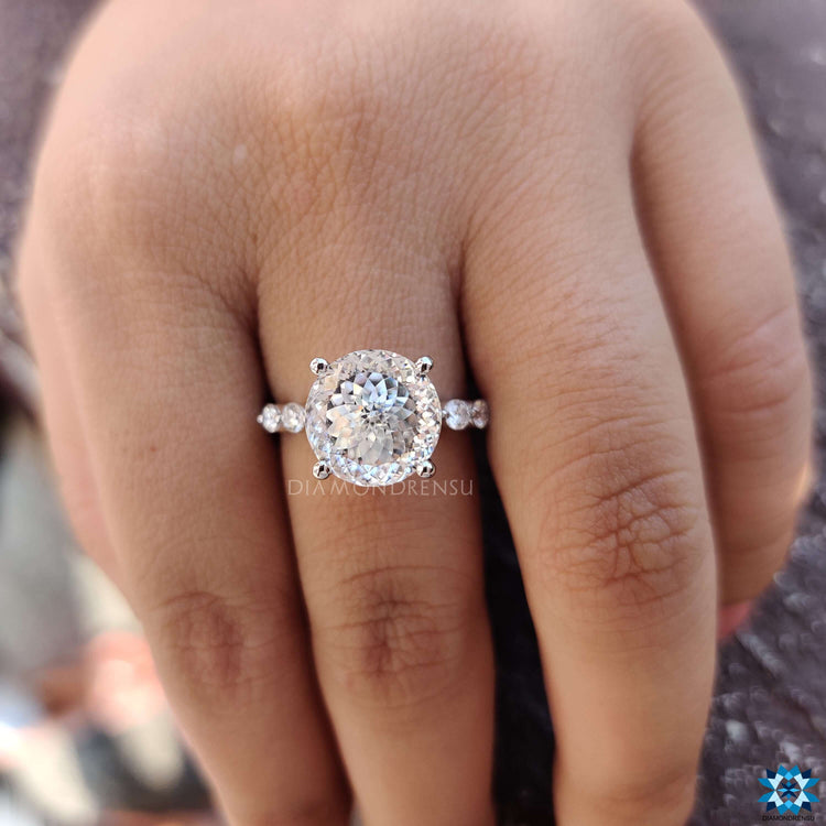 Pave engagement ring featuring a Portuguese cut center and round side stones.