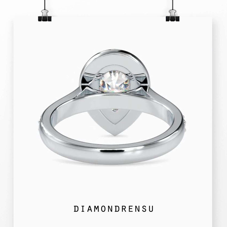 Yellow gold diamond ring featuring pear cut centre stone.