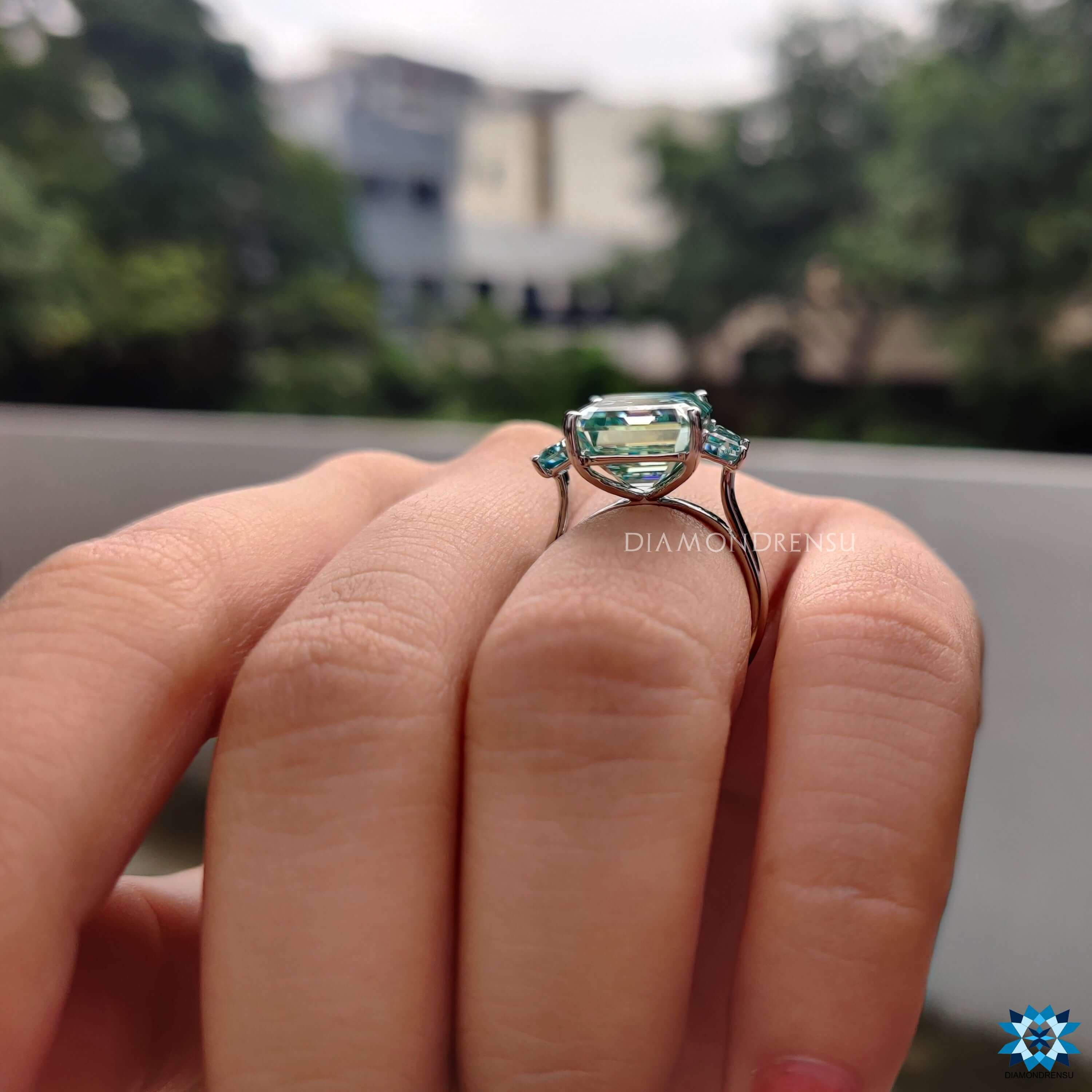 Cyan moissanite ring with clean prong setting.