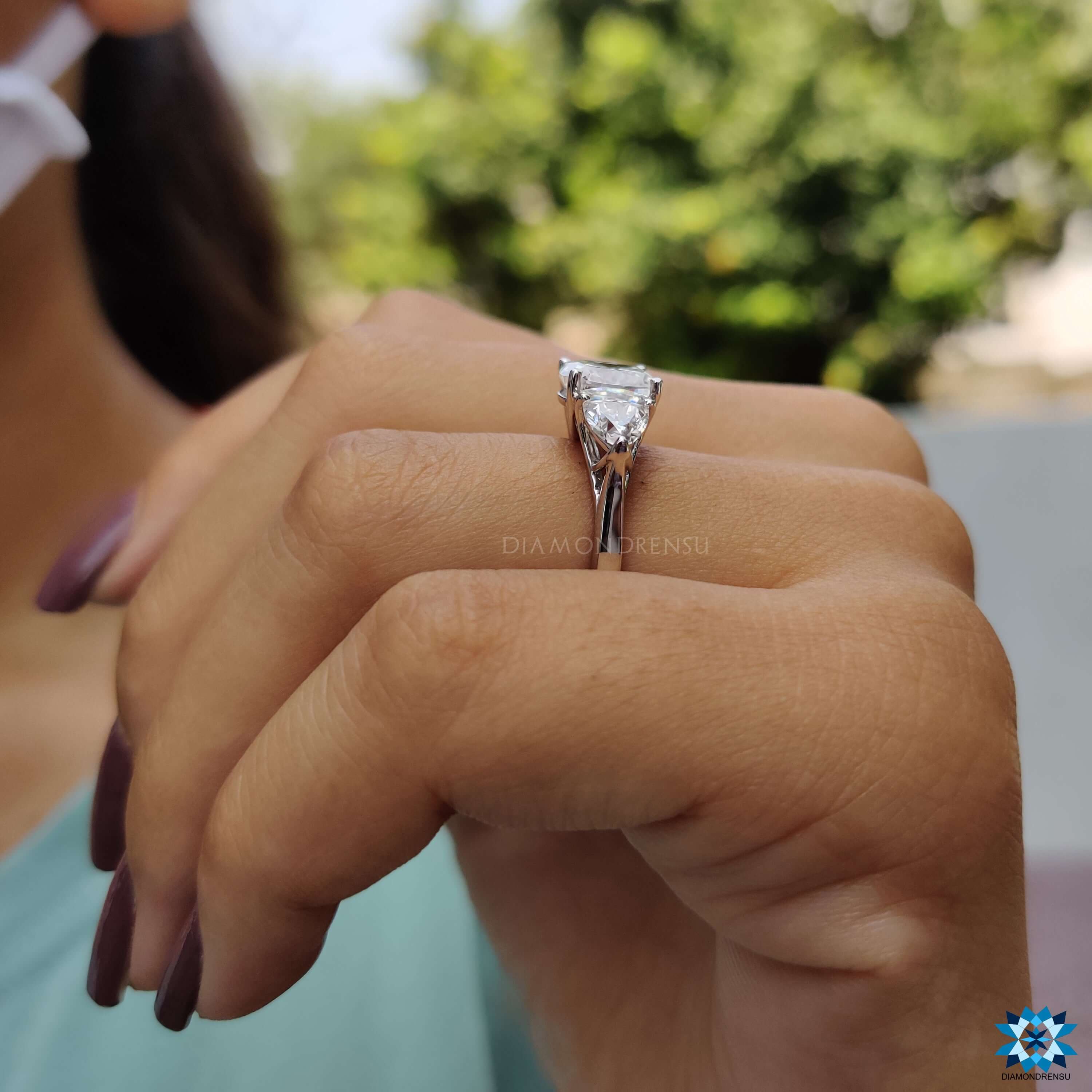 Custom white gold ring with cushion and trillion moissanites.