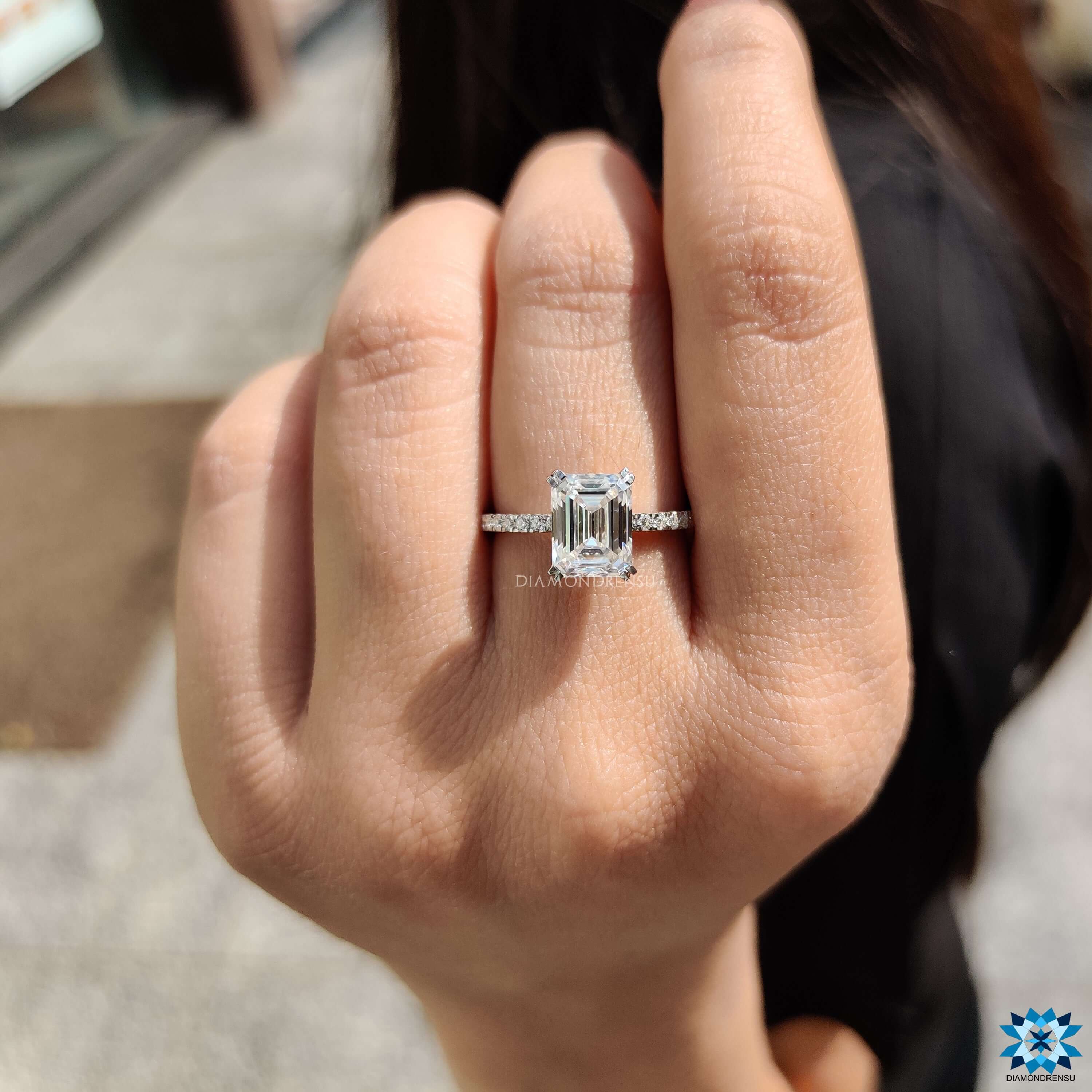 Step cut emerald moissanite ring set in double prong white gold setting.