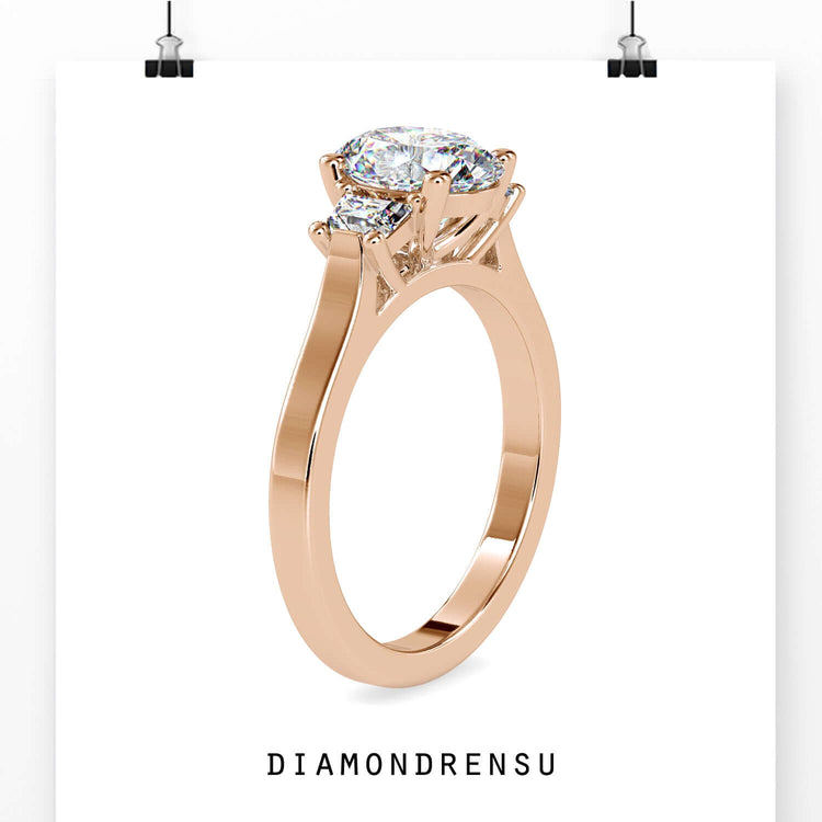 Rose gold diamond ring with oval and trapezium stones.