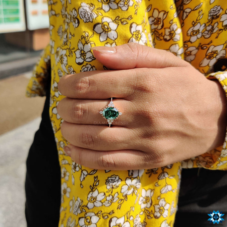Green oval cut moissanite engagement ring in rose gold.
