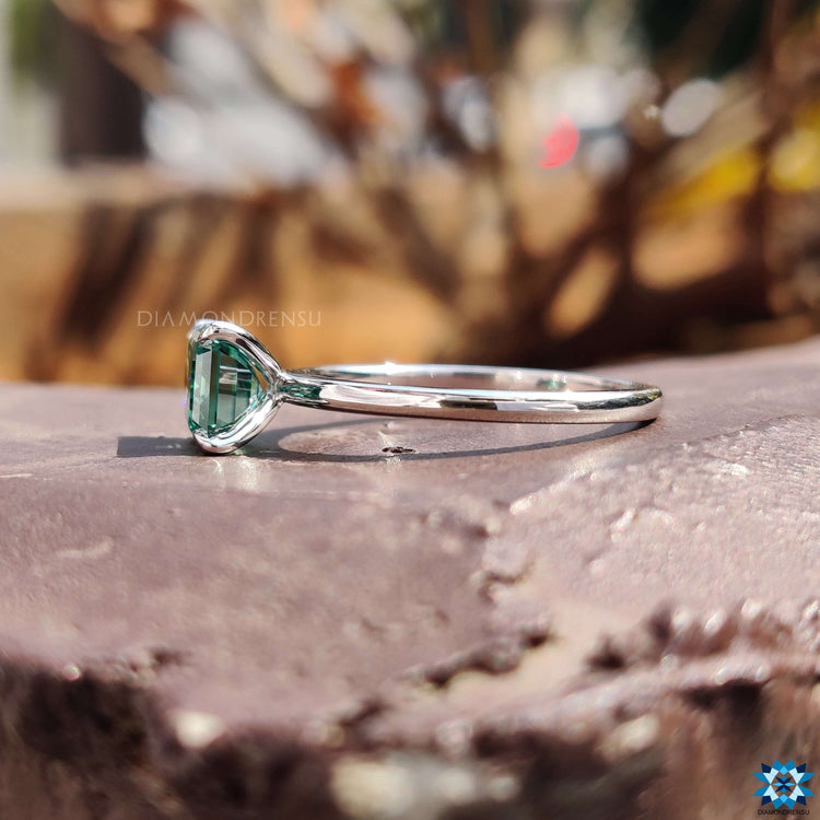 Prong setting ring with east west emerald cut stone.
