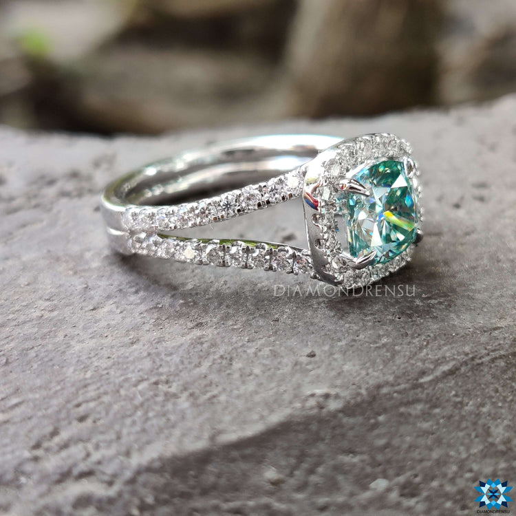 Split shank ring featuring cushion cut center.