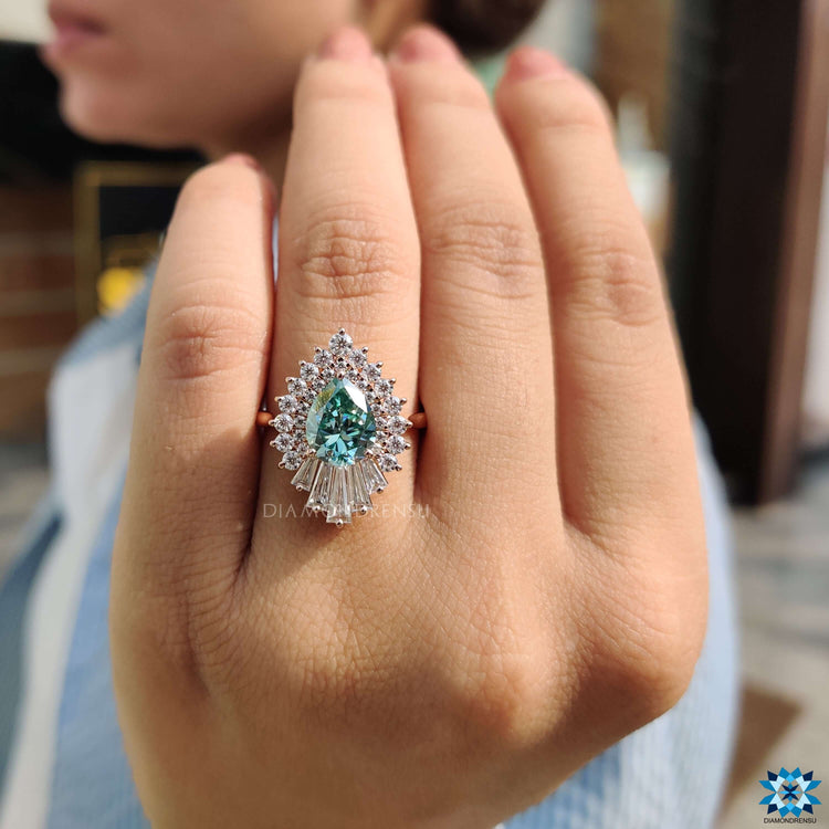 Cyan blue pear moissanite ring in rose gold.