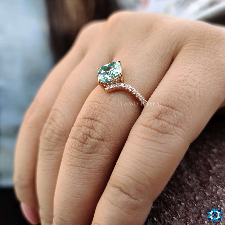 Custom moissanite engagement ring in rose gold with bypass setting.