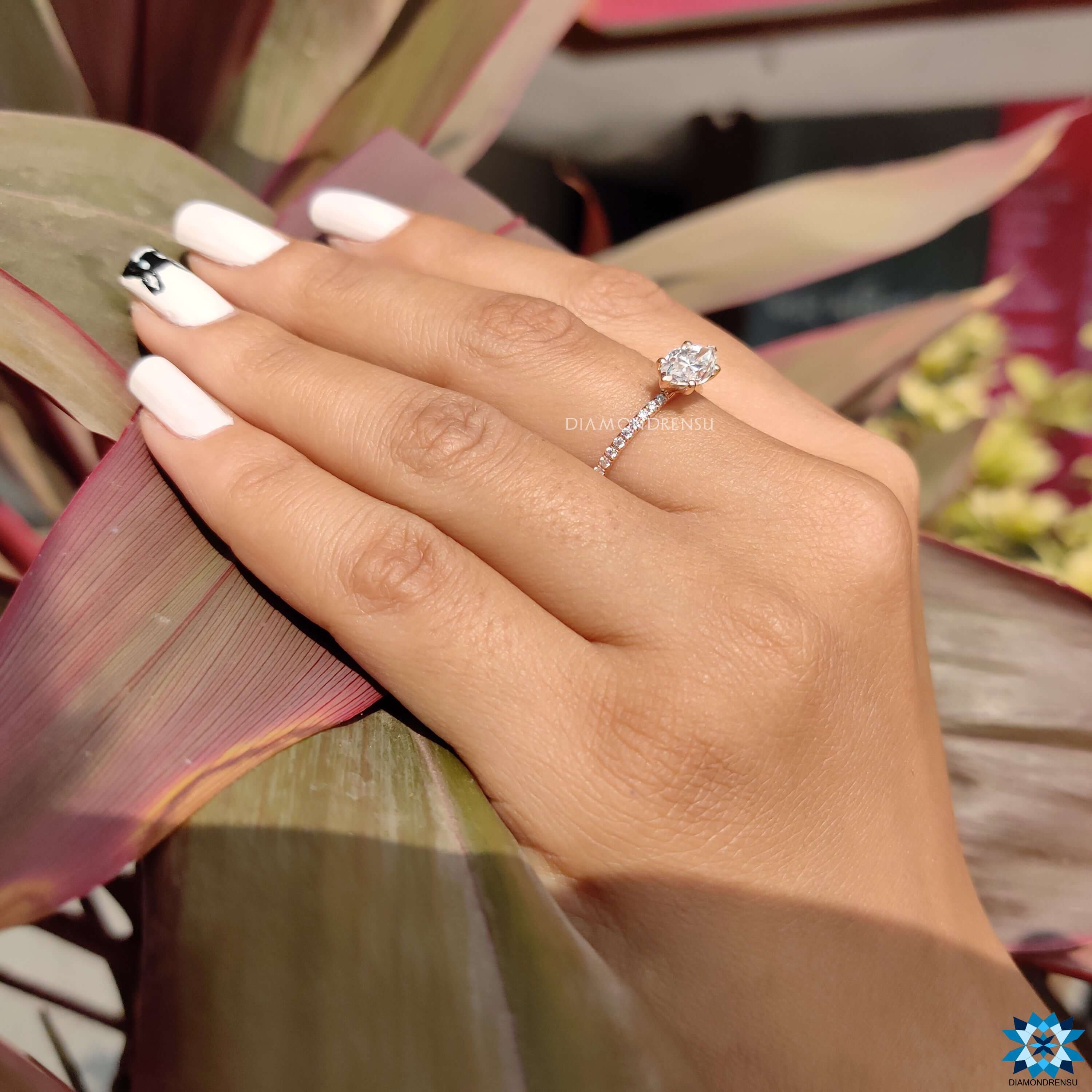 Rose gold moissanite ring with unique orientation.