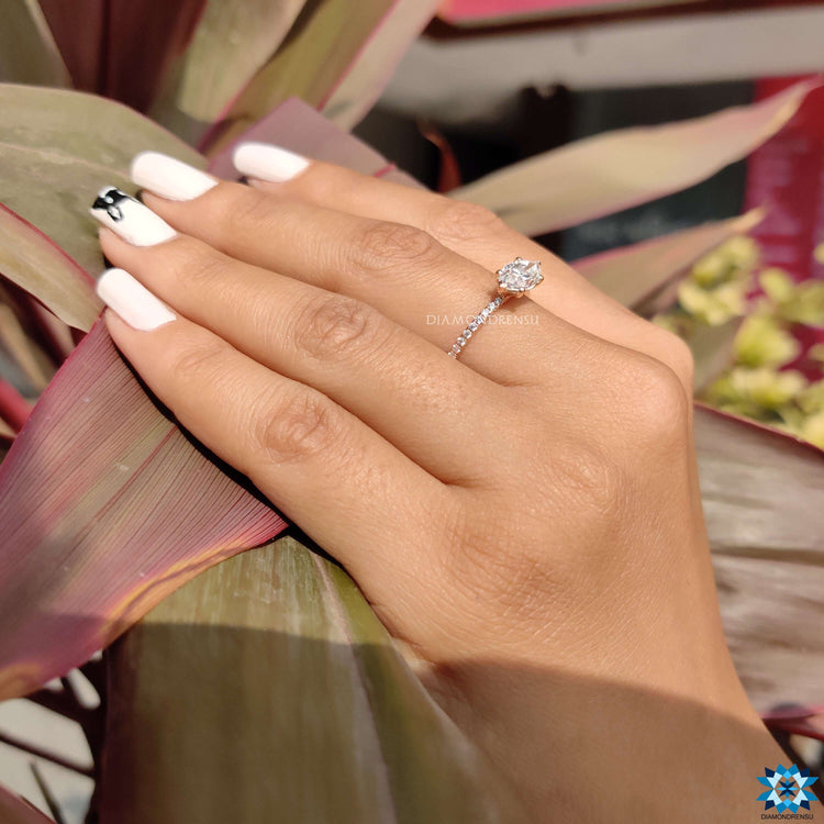 Rose gold moissanite ring with unique orientation.