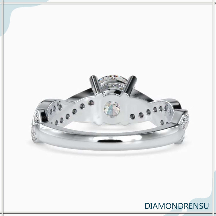 Diamondrensu UK ring with round cut and twisted pave band.
