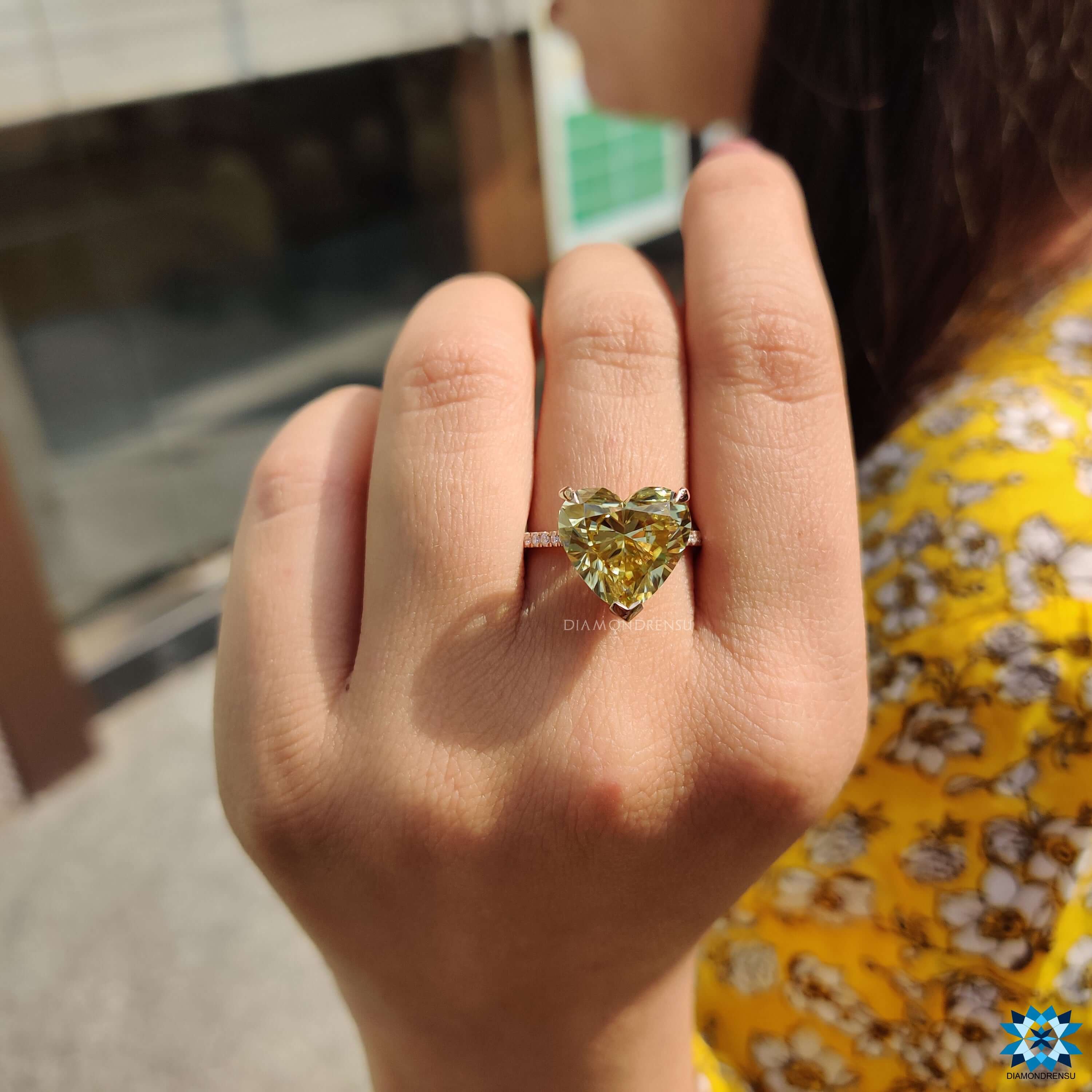 Claw prong ring with yellow canary moissanite.